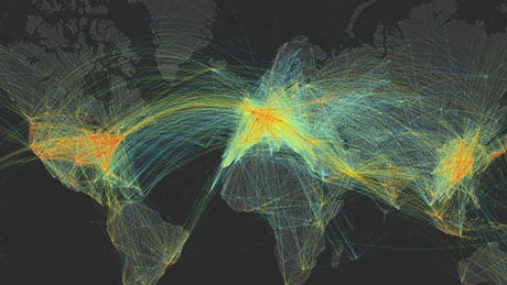 Lignes courbes colorées montrant le flux du trafic aérien sur une carte du monde