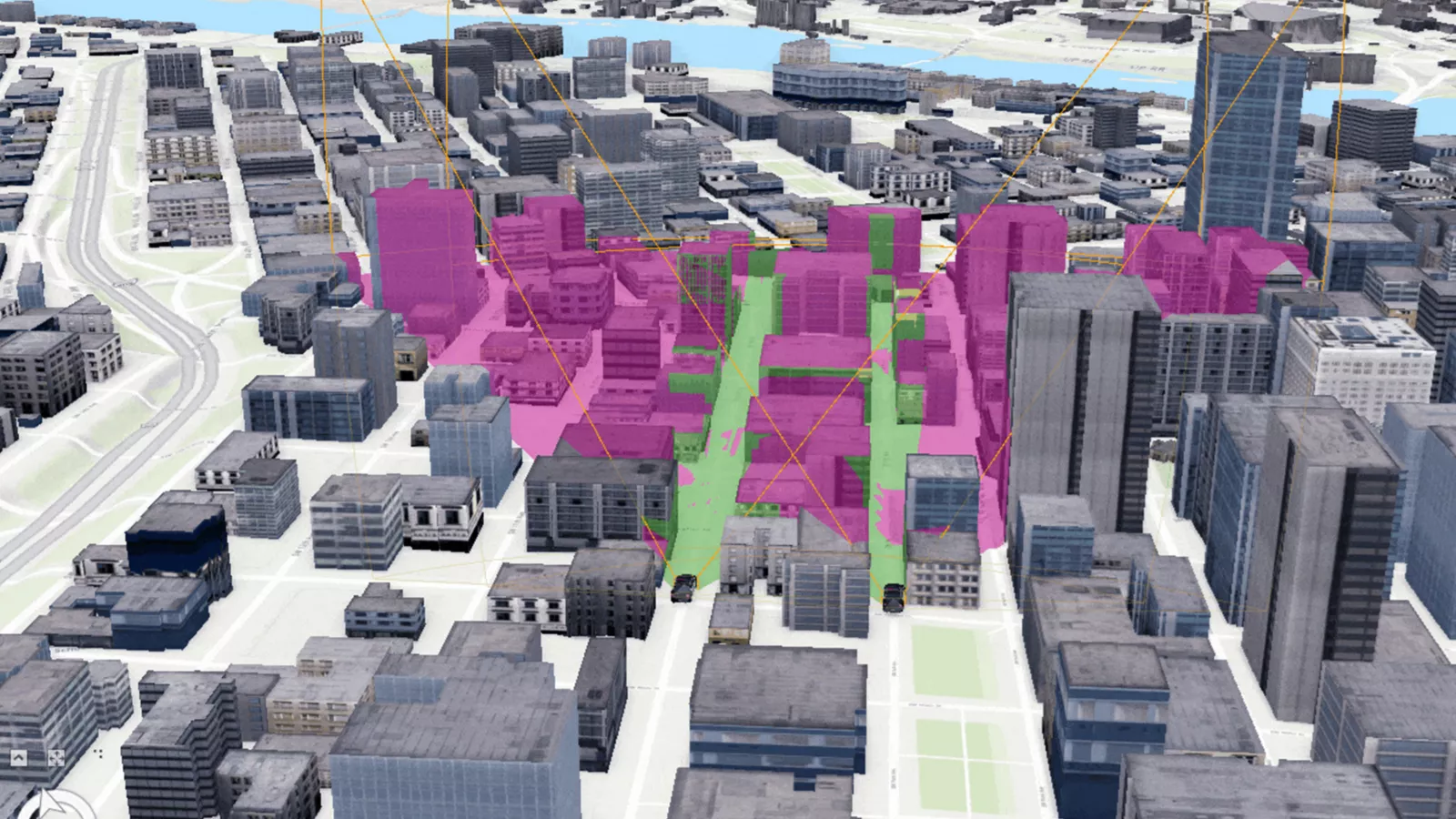 Modèle 3D d’un centre-ville. Plusieurs bâtiments sont mis en surbrillance dans des nuances de rose et de vert, indiquant les zones d’intérêt dans la ville.