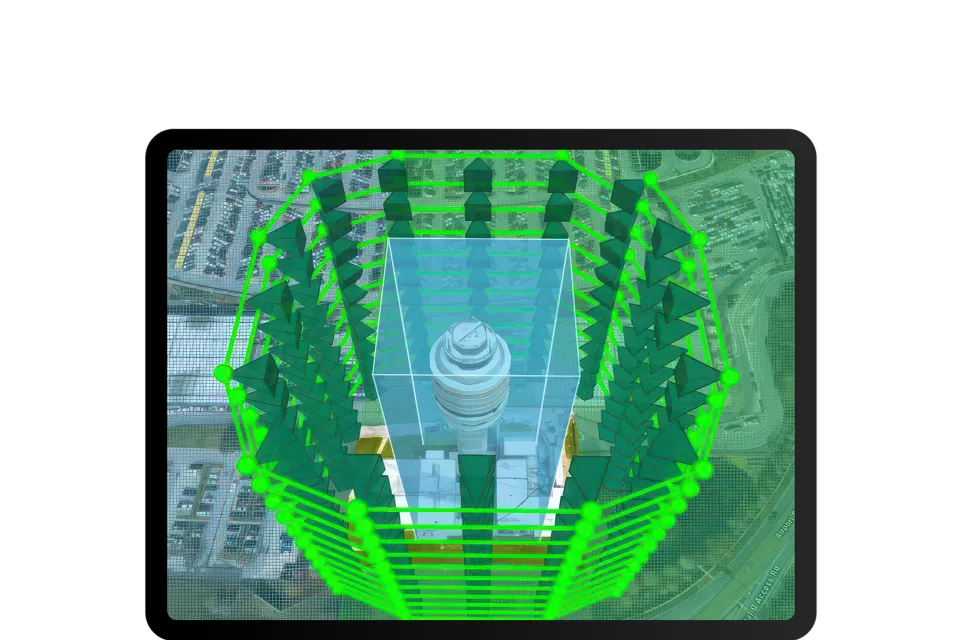 Tablette montrant un modèle de bâtiment 3D avec des lignes vertes représentant la simulation d’une structure.