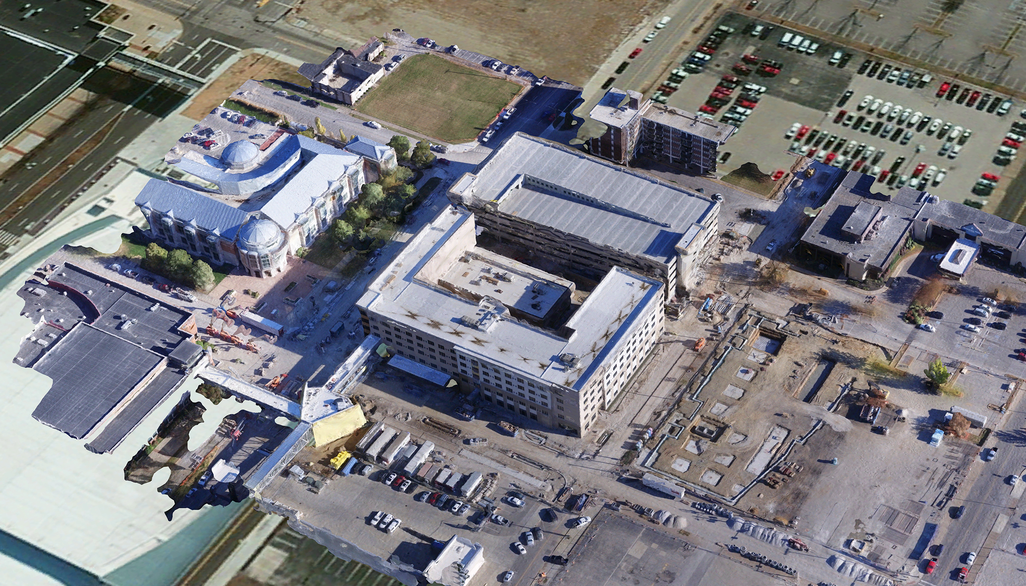 Modèle 3D d’un campus universitaire avec des voitures, des fenêtres et d’autres éléments représentés dans le détail