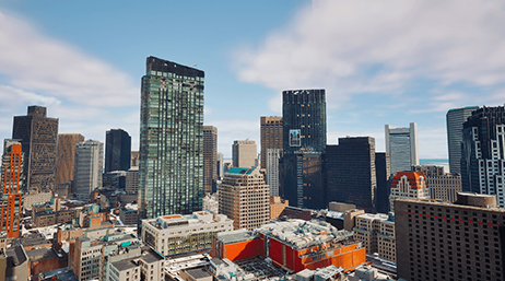 Image aérienne d’un modèle de ville en 3D sous un ciel bleu nuageux