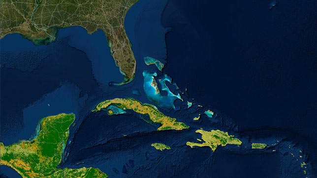 Zone de la mer des Caraïbes dont les îles apparaissent en jaune et en vert et zones de l’océan près de l’archipel des Keys en Floride apparaissant dans des tons de bleu plus lumineux que le reste de l’océan