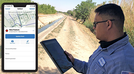 Travailleur nomade consultant une tablette à côté d'un aqueduct sur lequel est placé un appareil affichant une interface ArcGIS