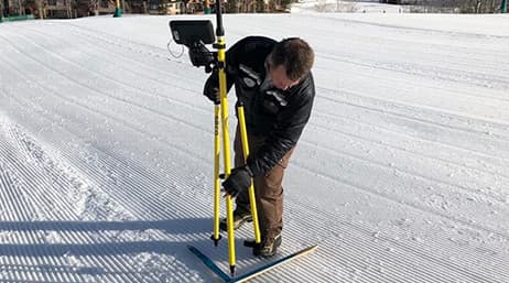Mike Krois, analyste SIG à Vail Ski Resort, utilisant une unité GPS sur la neige pour prendre des mesures précises destinées au jumeau numérique de Vail