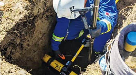 Opérateur de terrain utilisant son équipement à l’extérieur dans une tranchée