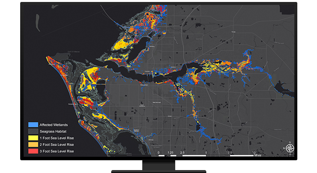 Ordinateur de bureau affichant une carte avec des zones en surbrillance qui ont été impactées par des inondations et autres bassins versants